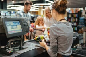 beautiful family standing cash counter